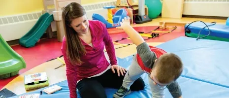 A woman interacting with a young child.